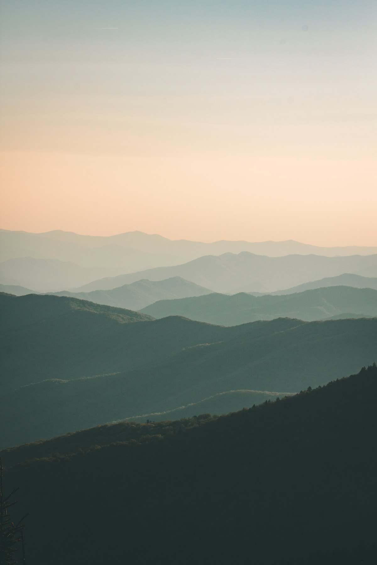 Traveler standing in dramatic dreamlike landscape during sunset