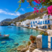 Hidden Greek island with crystal-clear turquoise water, whitewashed houses, colorful bougainvillea, and traditional coastal village in Greece