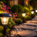 Solar garden lights illuminating a stone pathway in a landscaped backyard at night