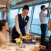 Cruise ship crew members working onboard a luxury cruise liner while serving passengers